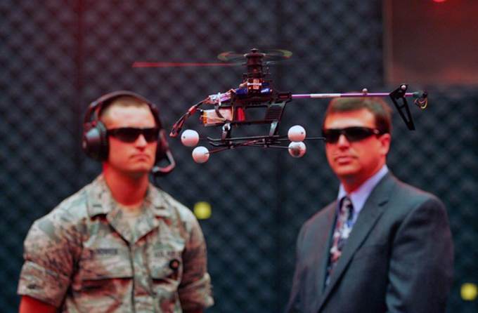 U.S. Air Force First Lieutenant Greg Sundbeck and Gregory Parker observe a test flight of a drone in the microaviary lab at Wright Patterson Air Force Base in Dayton Ohio